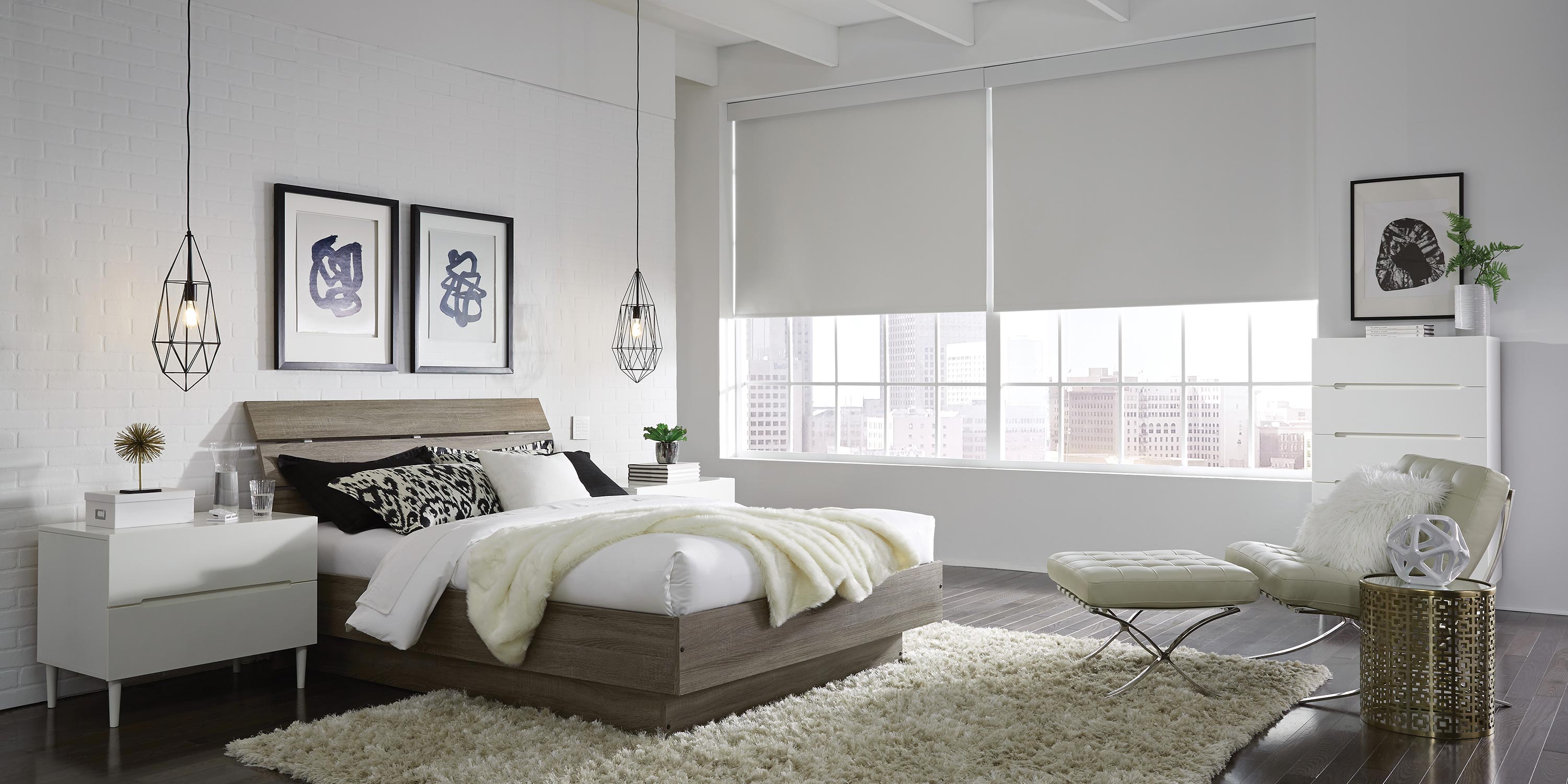 Modern bedroom with large windows, neutral decor, and cozy furnishings.