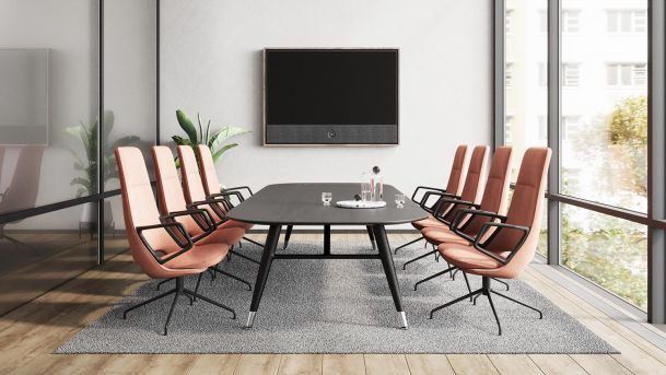 Bright conference room with floor-to-ceiling windows and a mounted screen.