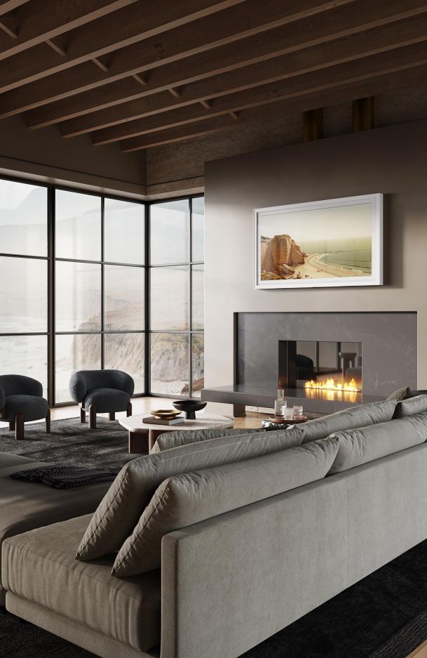 Modern living room with a fireplace, ocean view, and floor-to-ceiling windows.