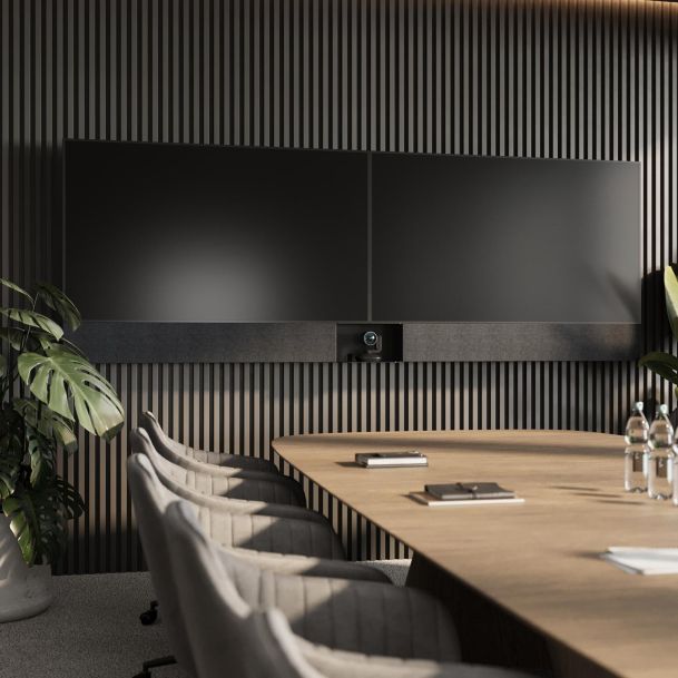 Sophisticated boardroom with a dual-screen display and wood-accented walls.