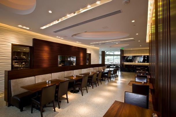 Elegant restaurant interior with ambient lighting and a textured accent wall.