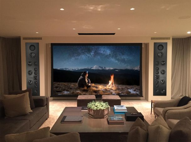 Luxury home theater with a massive screen and built-in speaker system.