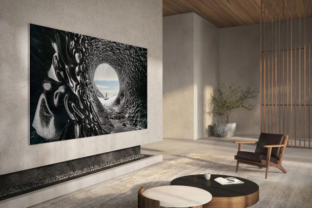 Minimalist living space with a large TV displaying an artistic nature scene.