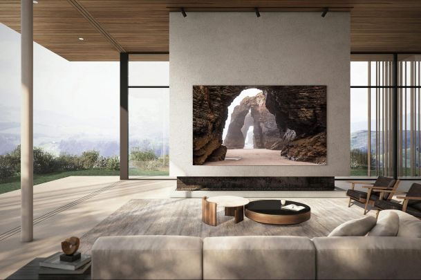 Modern living room with a floor-to-ceiling TV and an open outdoor view.