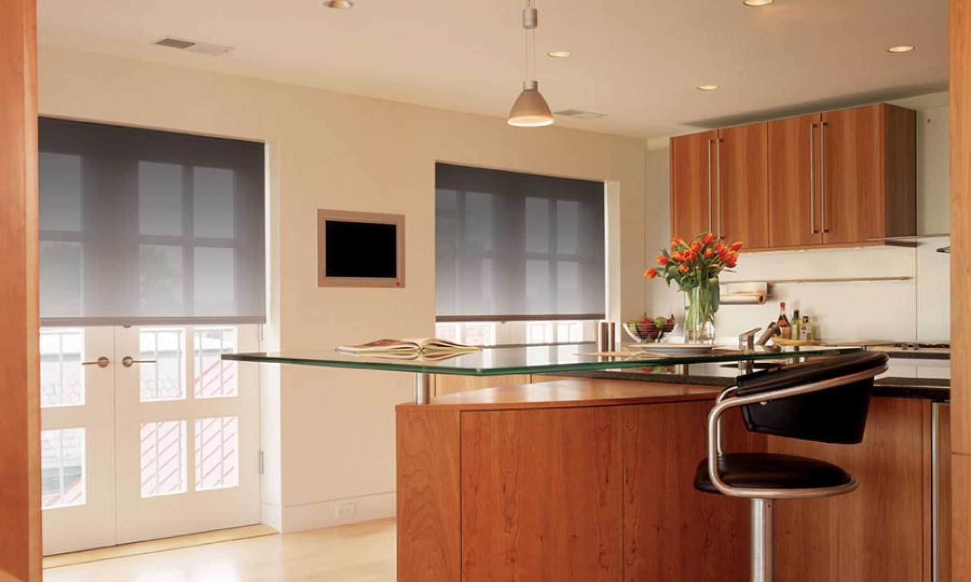 Kitchen with stylish, automated blinds and wood cabinetry, providing a warm ambiance.